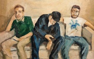 three people on a white sofa