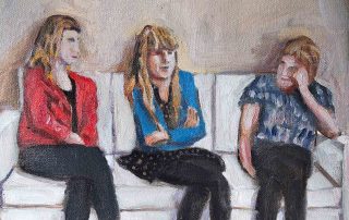 three people on a white sofa